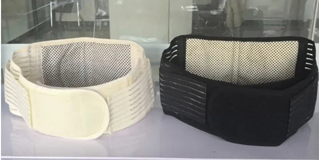 Black self-heating waist protection fixed belt with magnetic therapy for lumbar support on a beige background.