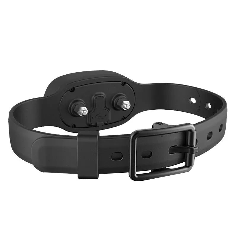 Black remote-controlled dog training collar with receiver unit and handheld transmitter on a table.