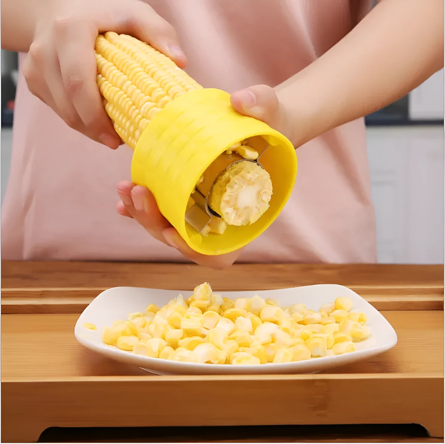 Yellow manual corn grinder thresher with a corn-kernel shaped PP handle and stainless steel peeling gear.