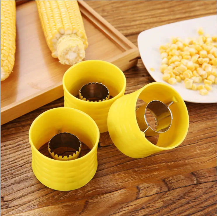 Yellow manual corn grinder thresher with a corn-kernel shaped PP handle and stainless steel peeling gear.