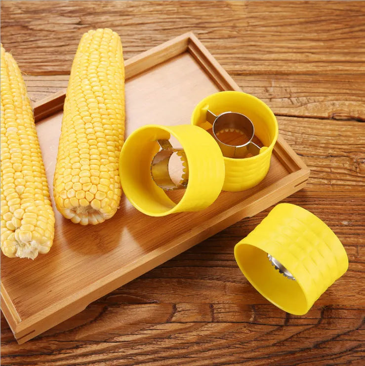 Yellow manual corn grinder thresher with a corn-kernel shaped PP handle and stainless steel peeling gear.