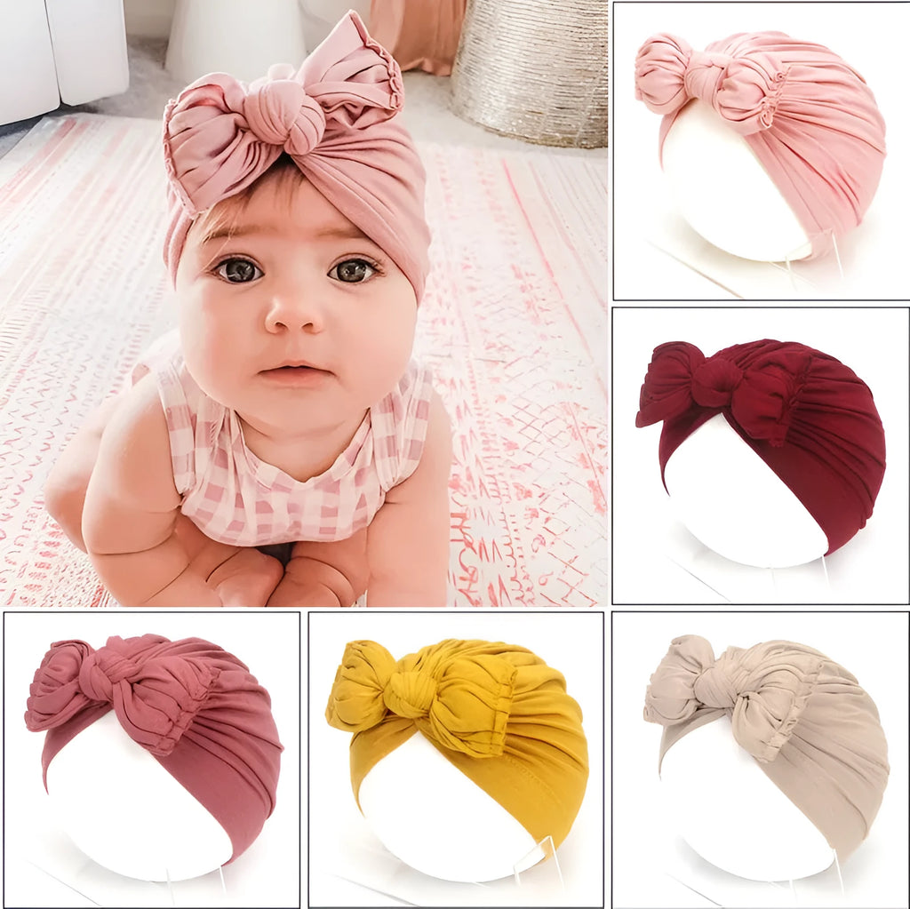 Soft knitted acrylic turban hat for baby girls, shown in a pink colour, fits head size 35-48cm.