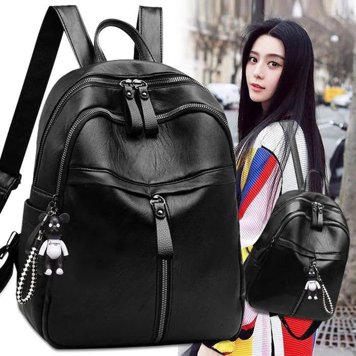 Black soft surface PU leather backpack with double straps showing ID compartment and zipper opening