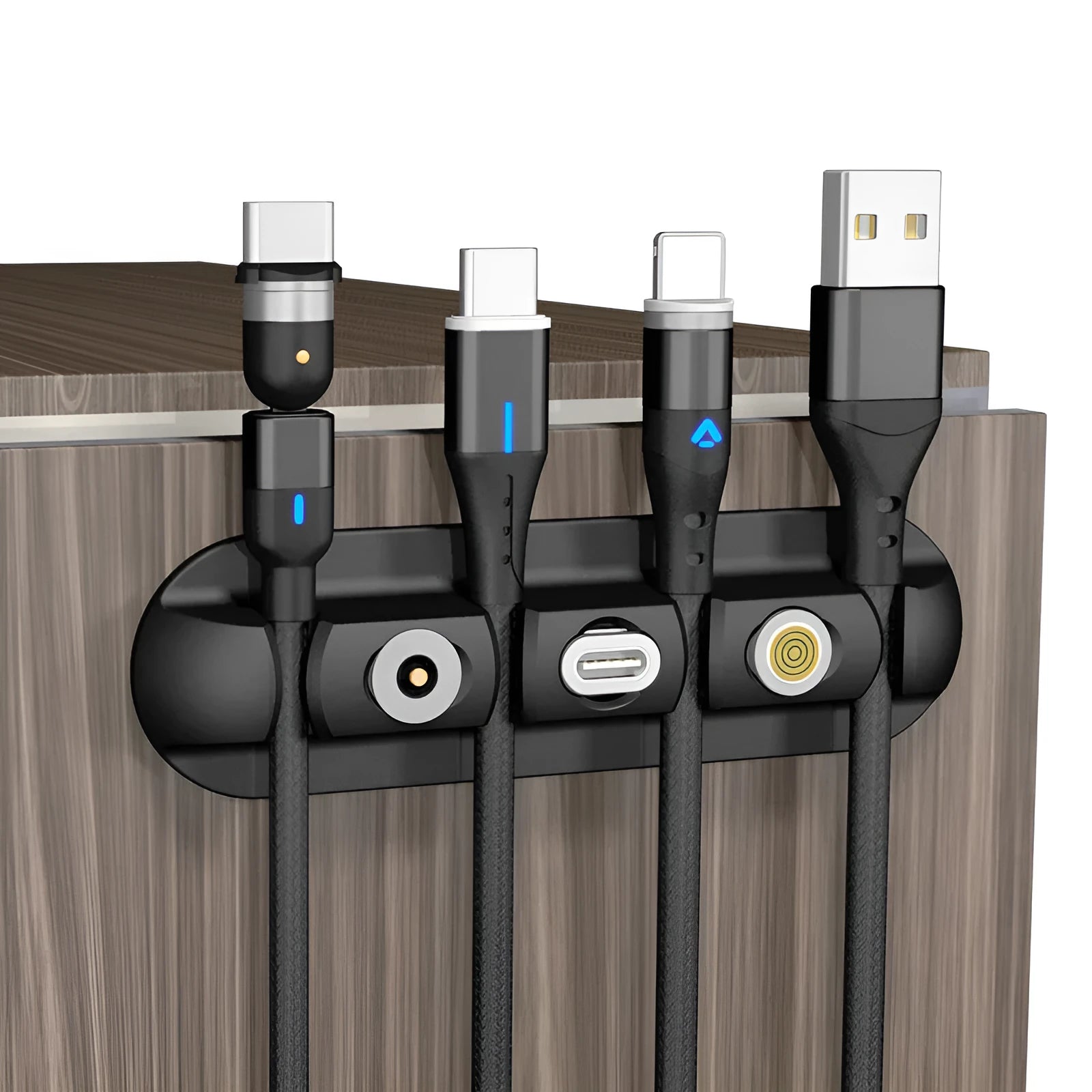 Black soft plastic desktop magnetic charging cable organizer on a wooden desk.