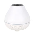 Round white Bluetooth humidifier and aroma diffuser with essential oil tank and night light.