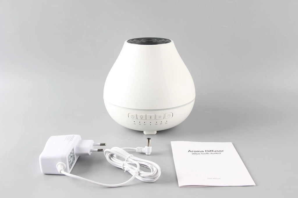 Round white Bluetooth humidifier and aroma diffuser with essential oil tank and night light.