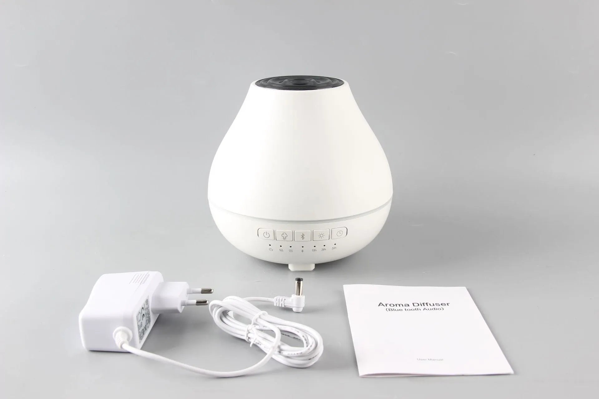 Round white Bluetooth humidifier and aroma diffuser with essential oil tank and night light.