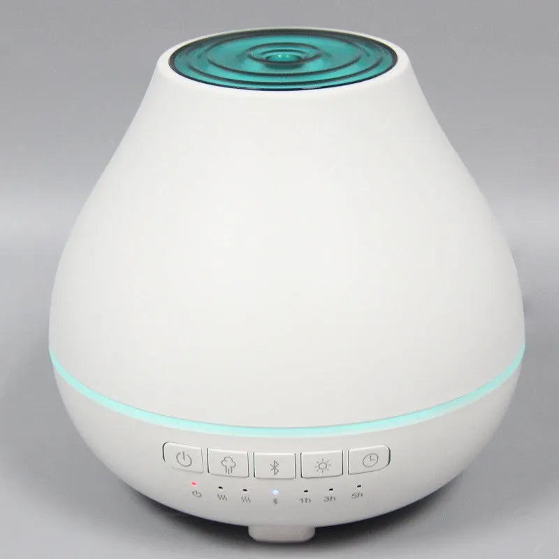 Round white Bluetooth humidifier and aroma diffuser with essential oil tank and night light.