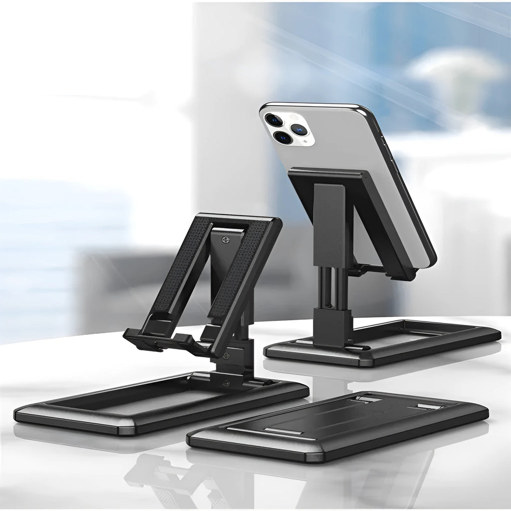 Retractable mobile phone desktop stand in black colour, folded and placed on a desk