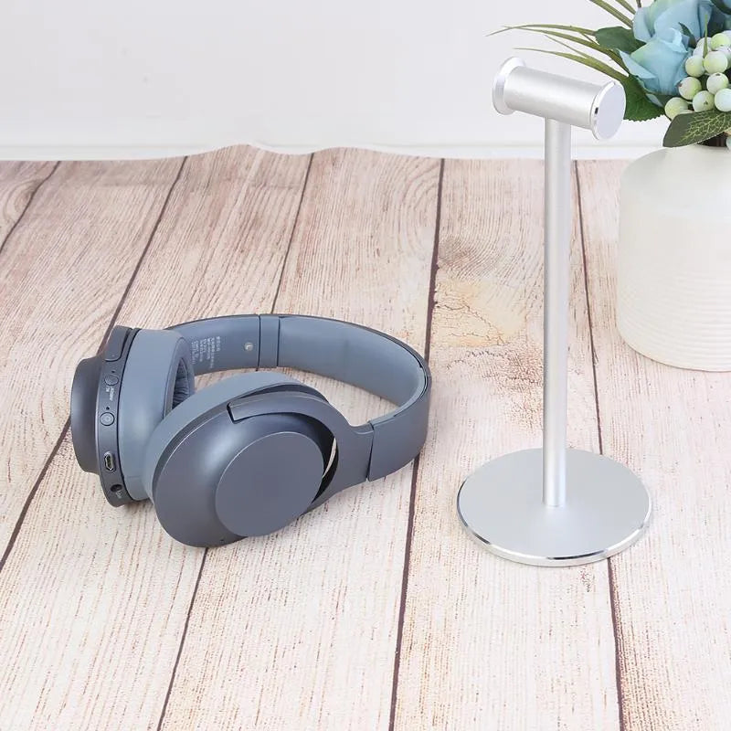 Aluminum alloy black headset bracket storage rack on desk holding a gaming headset
