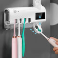 Wall-mounted UV toothbrush sterilizer with automatic toothpaste squeezer in black finish