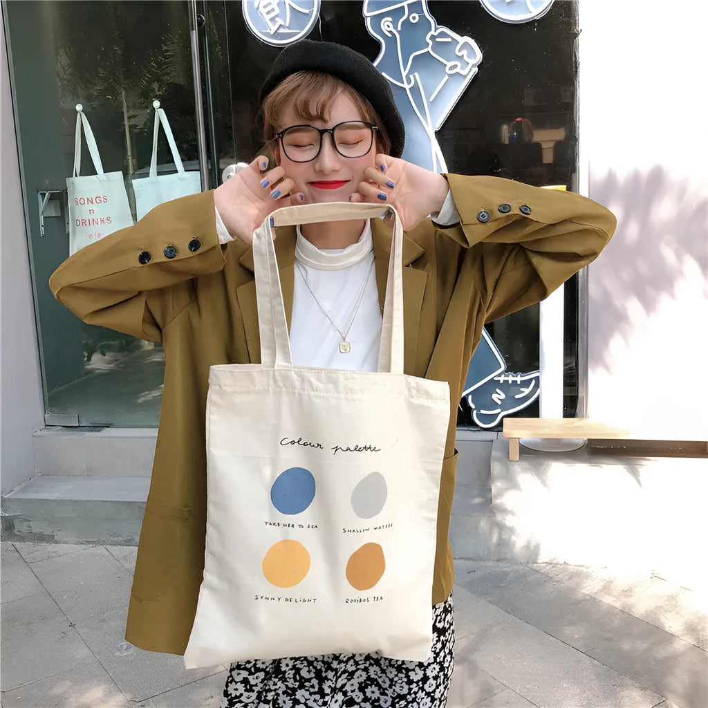 Women's medium canvas tote bag with geometric pattern, zipper closure, and double soft handles in orange or light pink.