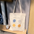 Women's medium canvas tote bag with geometric pattern, zipper closure, and double soft handles in orange or light pink.