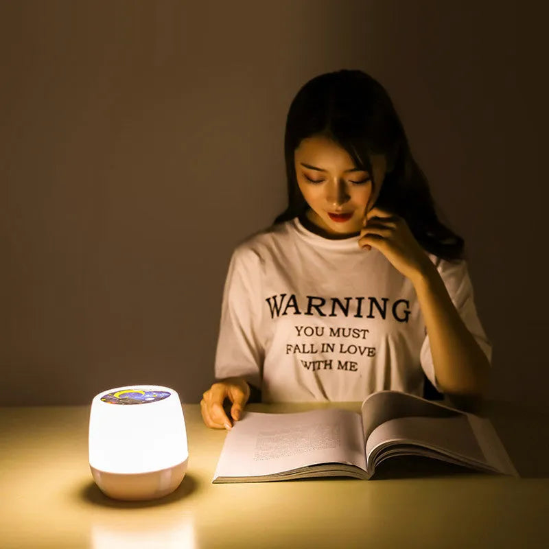 Projector night light displaying rotating star and moon patterns on a bedroom wall