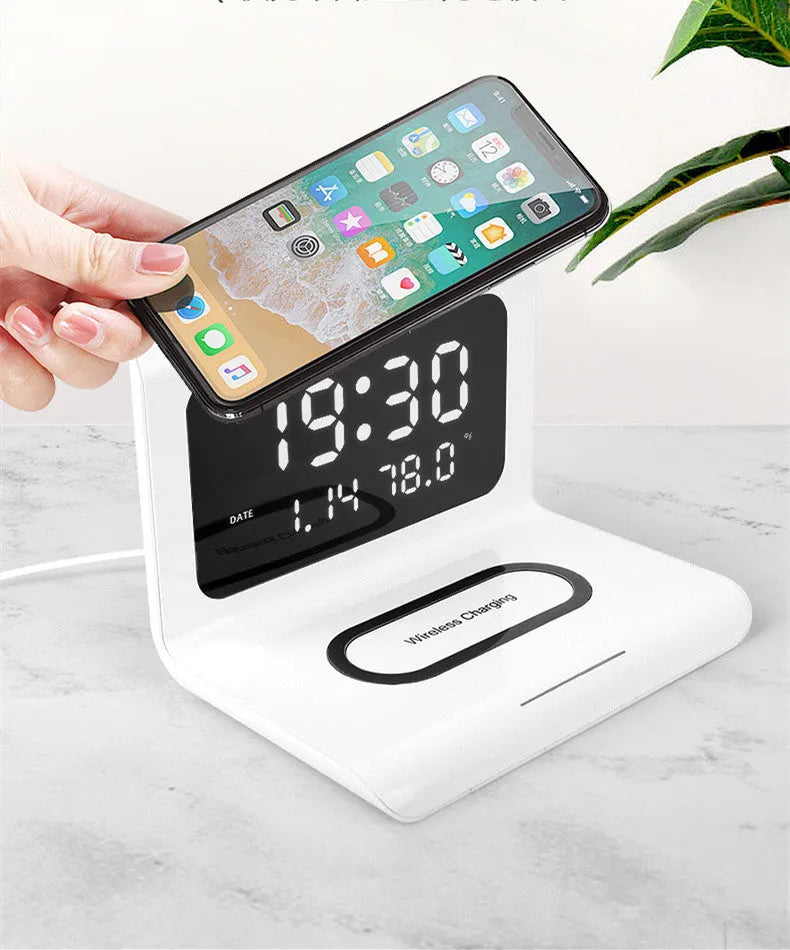 Black wireless charger alarm clock showing time, date, temperature and humidity on display with phone charging