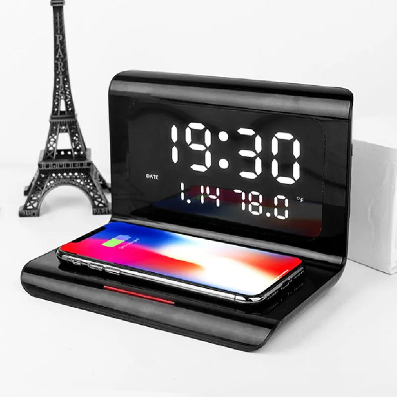 Black wireless charger alarm clock showing time, date, temperature and humidity on display with phone charging