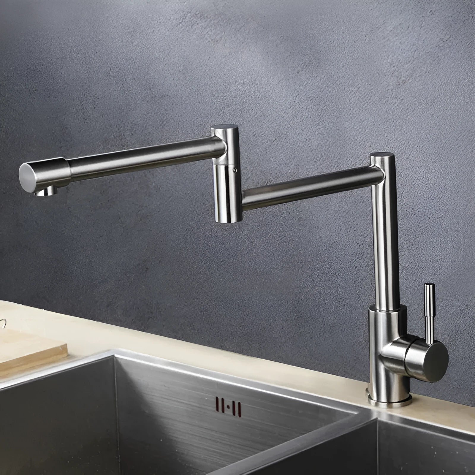 Silver stainless steel kitchen tap with a single lever and a 360-degree rotating spout.