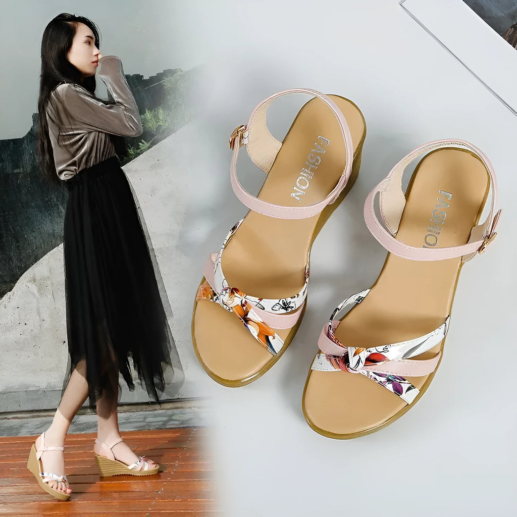 Women's pink wedge sandals with a thick platform heel and buckle strap.