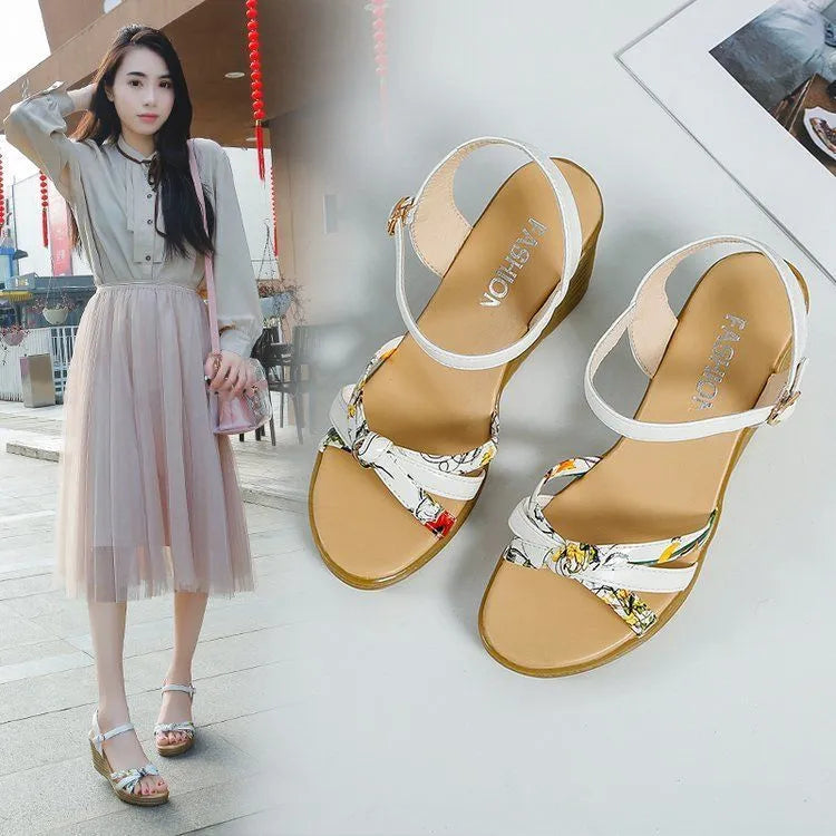 Women's pink wedge sandals with a thick platform heel and buckle strap.