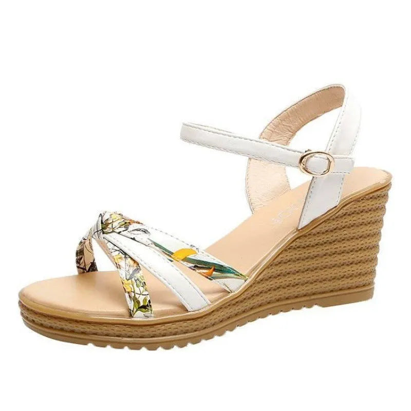 Women's pink wedge sandals with a thick platform heel and buckle strap.