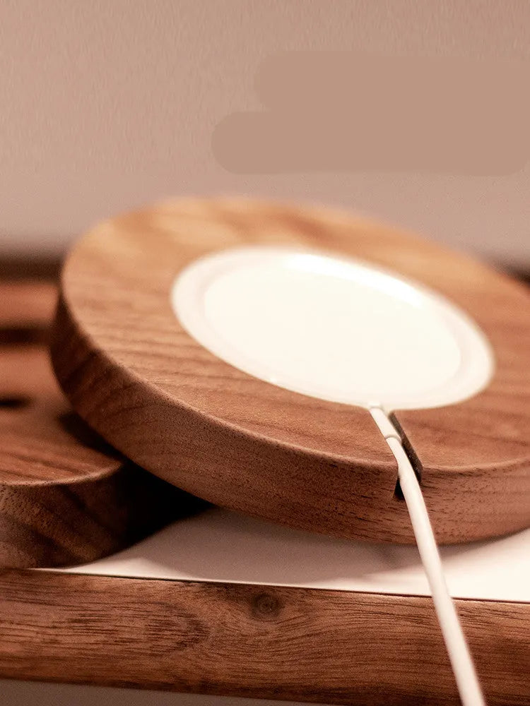 Walnut wood magnetic wireless charging base with MagSafe bracket on desktop
