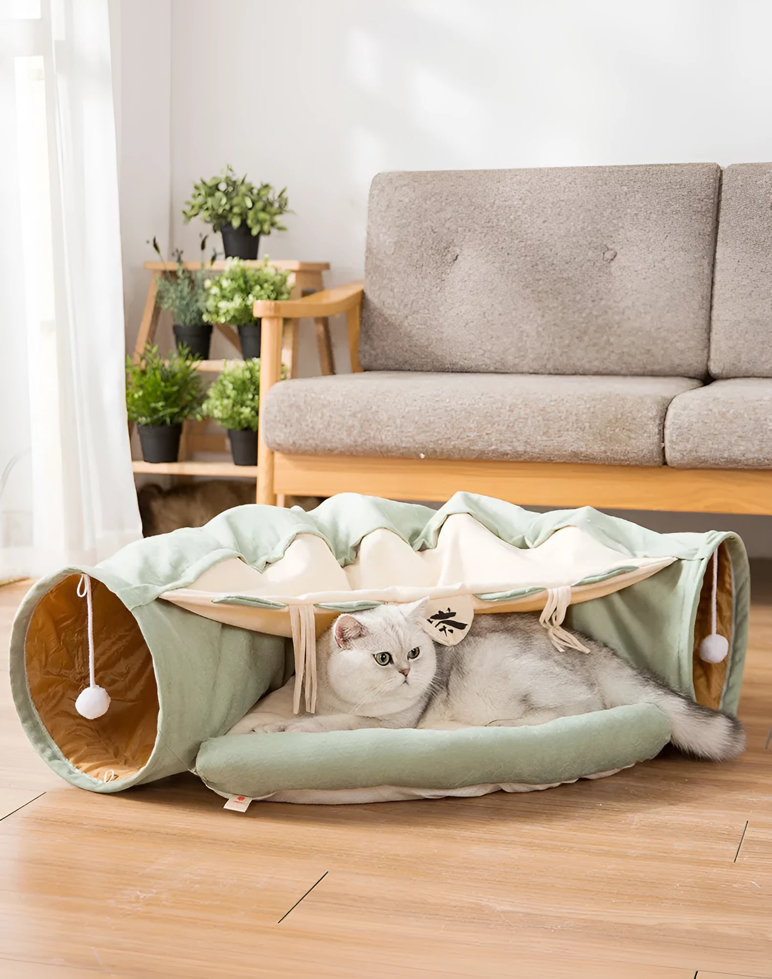 Collapsible cloth cat tunnel toy in pink, shown folded flat and opened for play