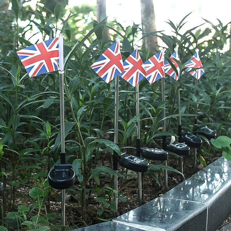 Solar garden flag light with stainless steel pole showing American flag design illuminated at night