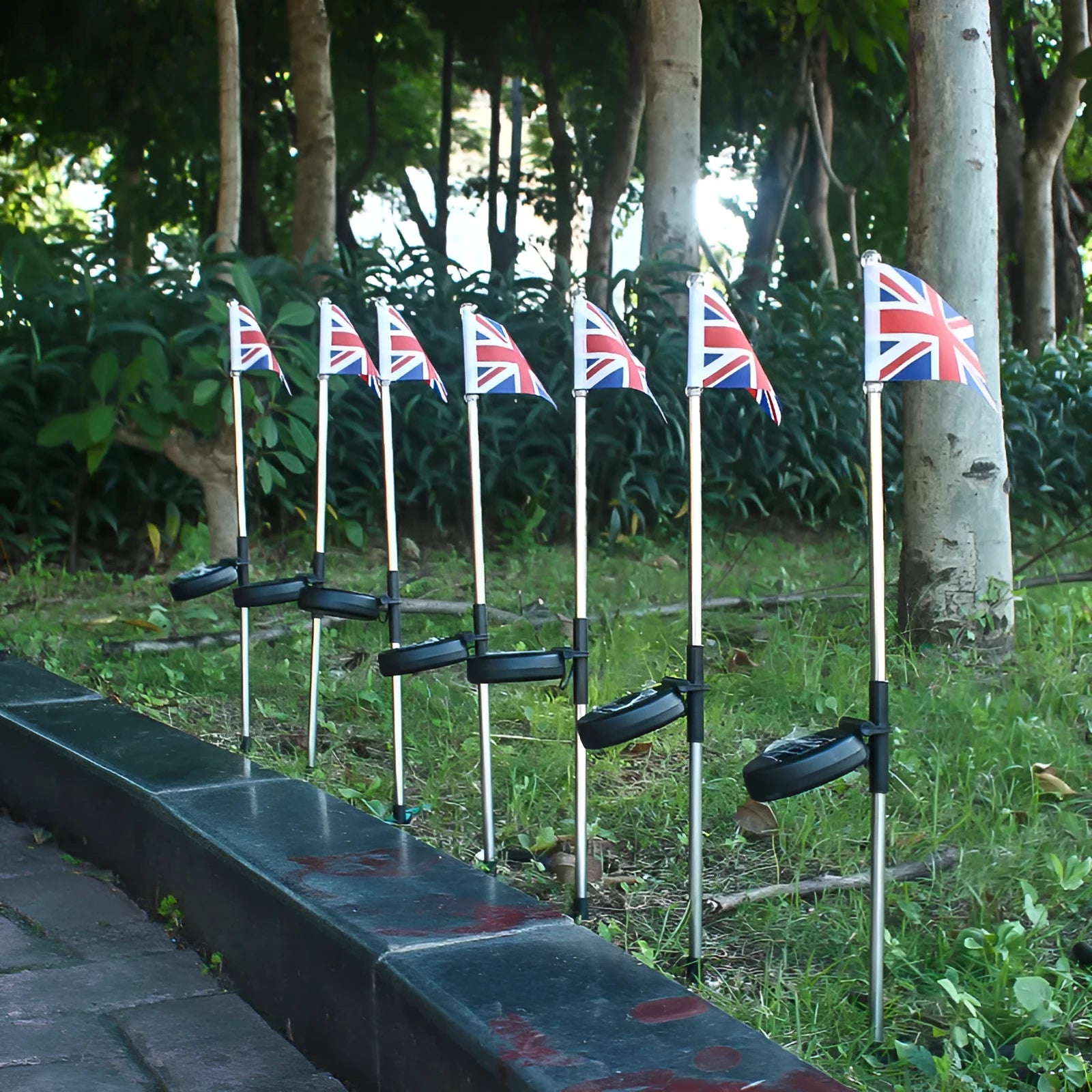 Solar garden flag light with stainless steel pole showing American flag design illuminated at night
