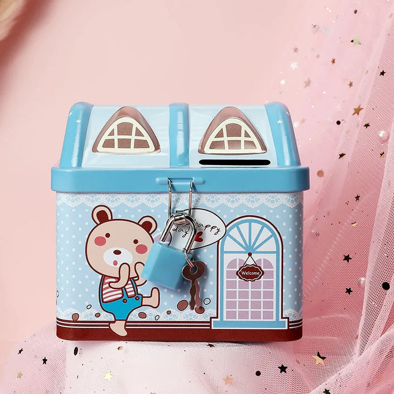 Blue house-shaped tinplate piggy bank on desktop showing round form and coin slot