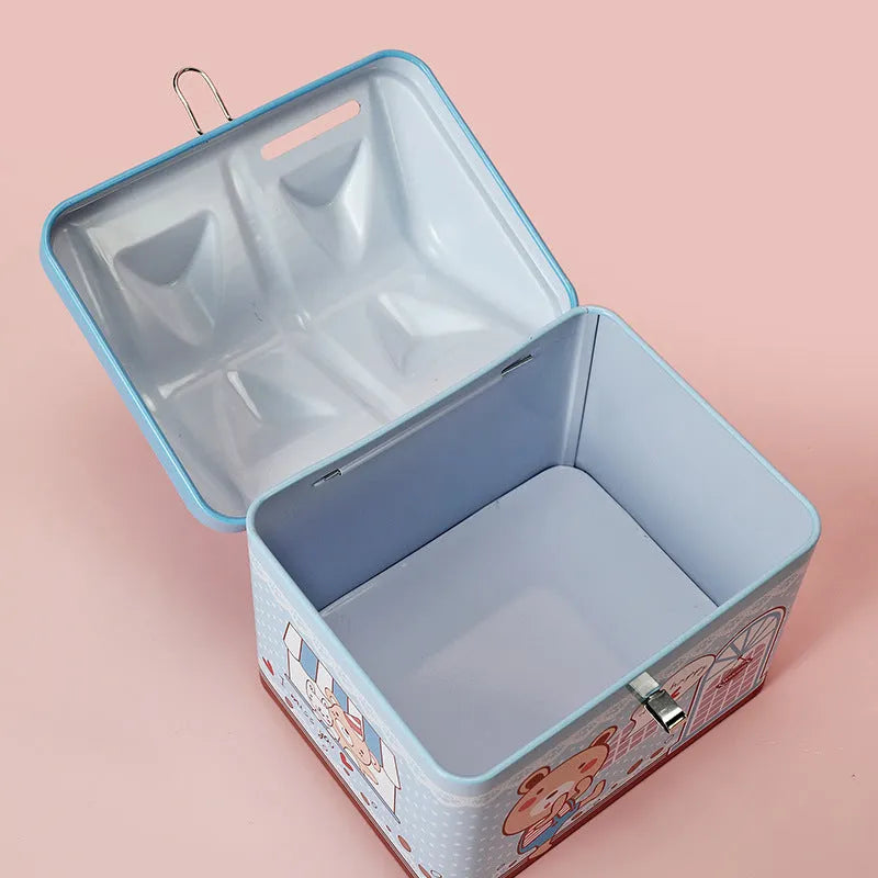 Blue house-shaped tinplate piggy bank on desktop showing round form and coin slot