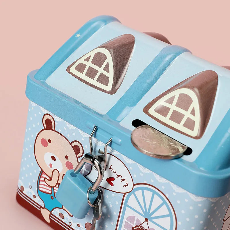 Blue house-shaped tinplate piggy bank on desktop showing round form and coin slot