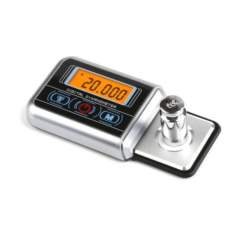 Compact black digital pocket scale on a table showing 0.00g on its LCD display.