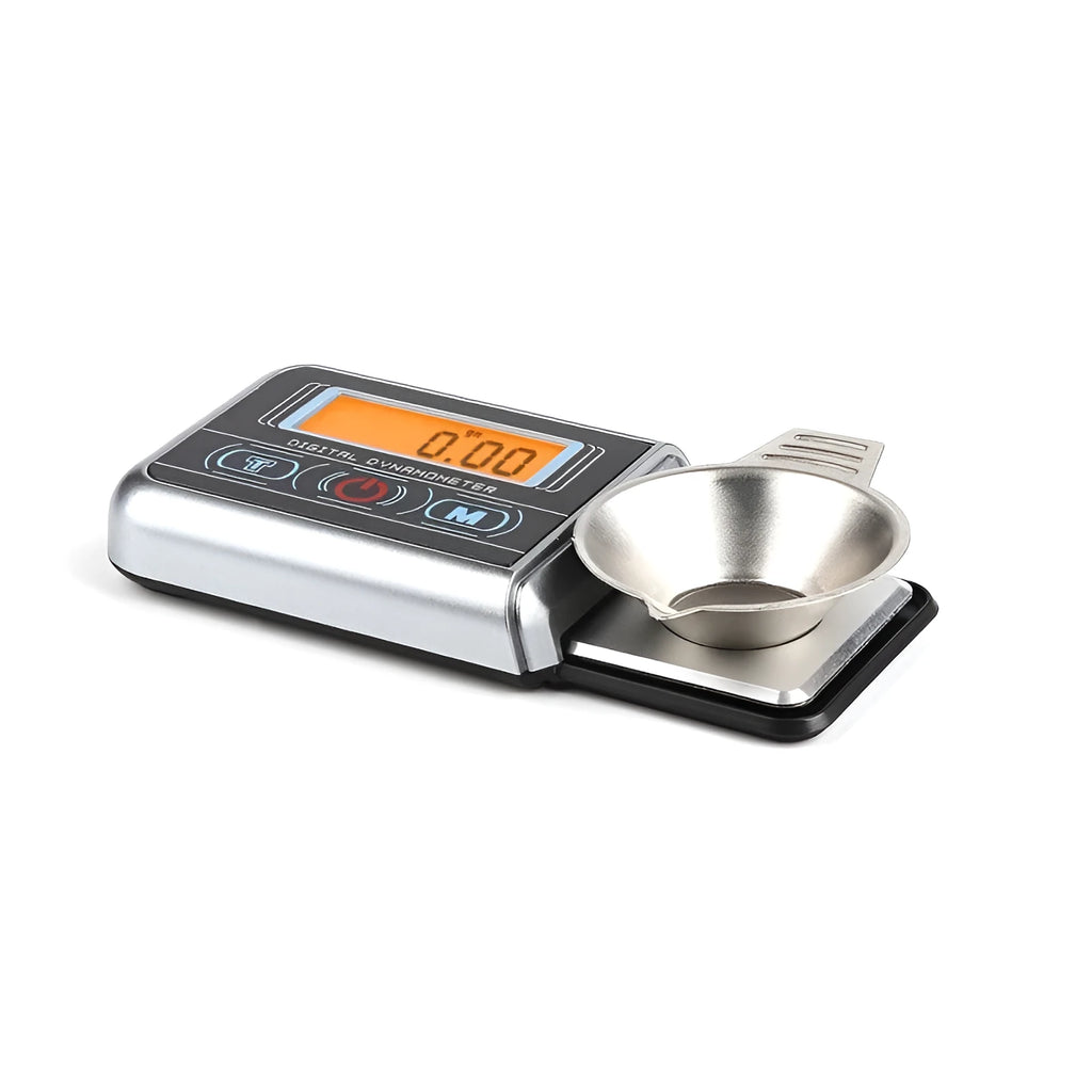 Compact black digital pocket scale on a table showing 0.00g on its LCD display.