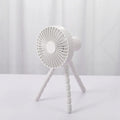 USB rechargeable portable desk fan with flexible octopus tripod and white colour option on a wooden table.