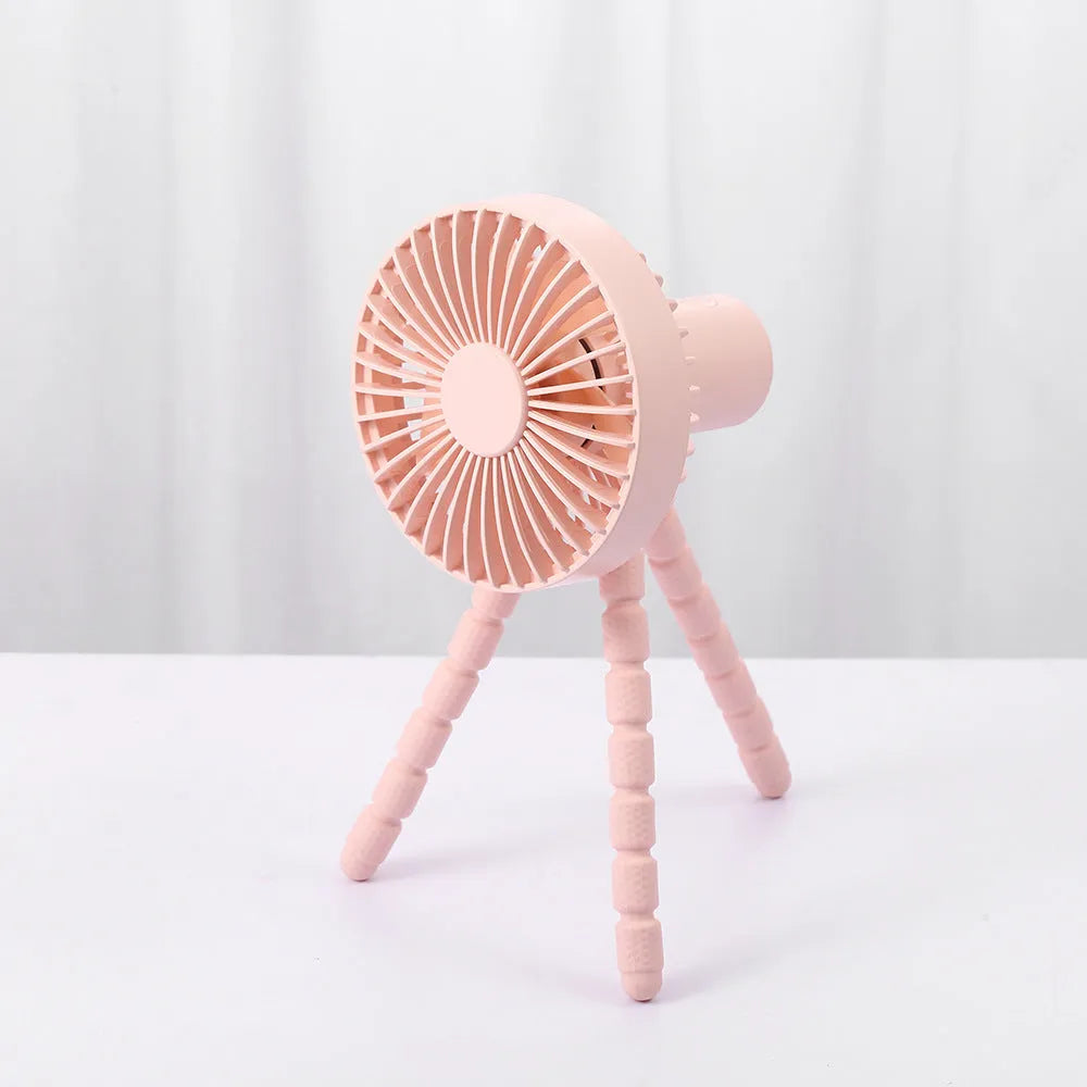 USB rechargeable portable desk fan with flexible octopus tripod and white colour option on a wooden table.