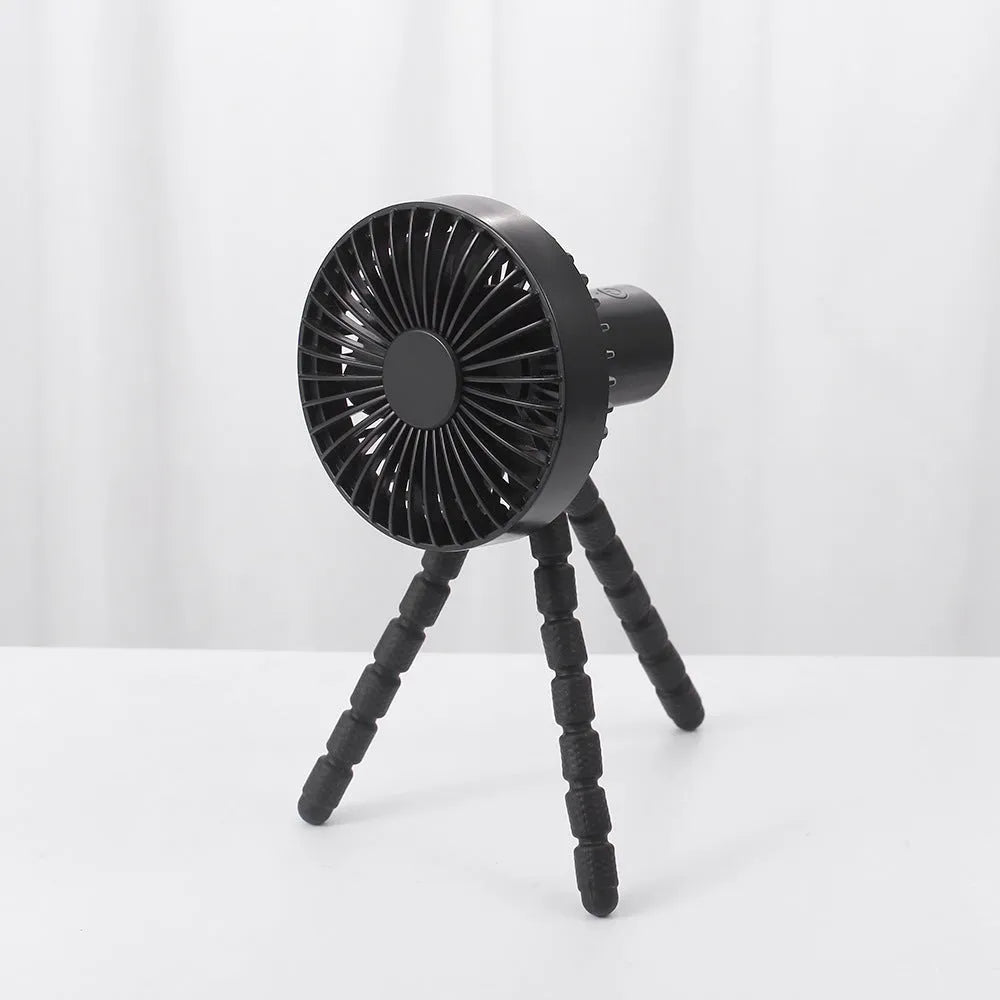 USB rechargeable portable desk fan with flexible octopus tripod and white colour option on a wooden table.