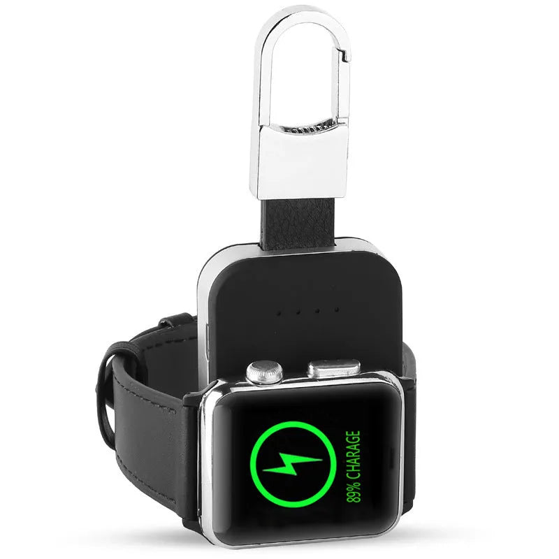 Black portable keychain power bank for wireless charging of Apple Watch on a white background.