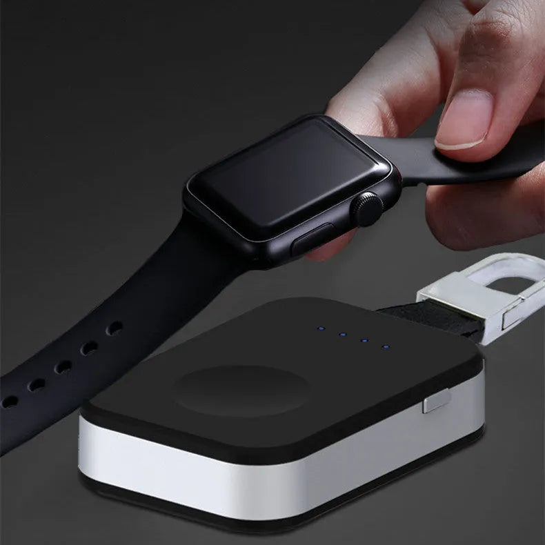 Black portable keychain power bank for wireless charging of Apple Watch on a white background.