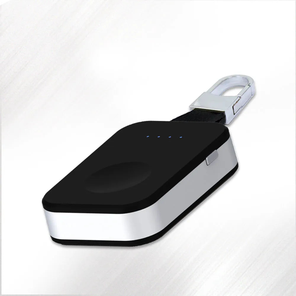 Black portable keychain power bank for wireless charging of Apple Watch on a white background.