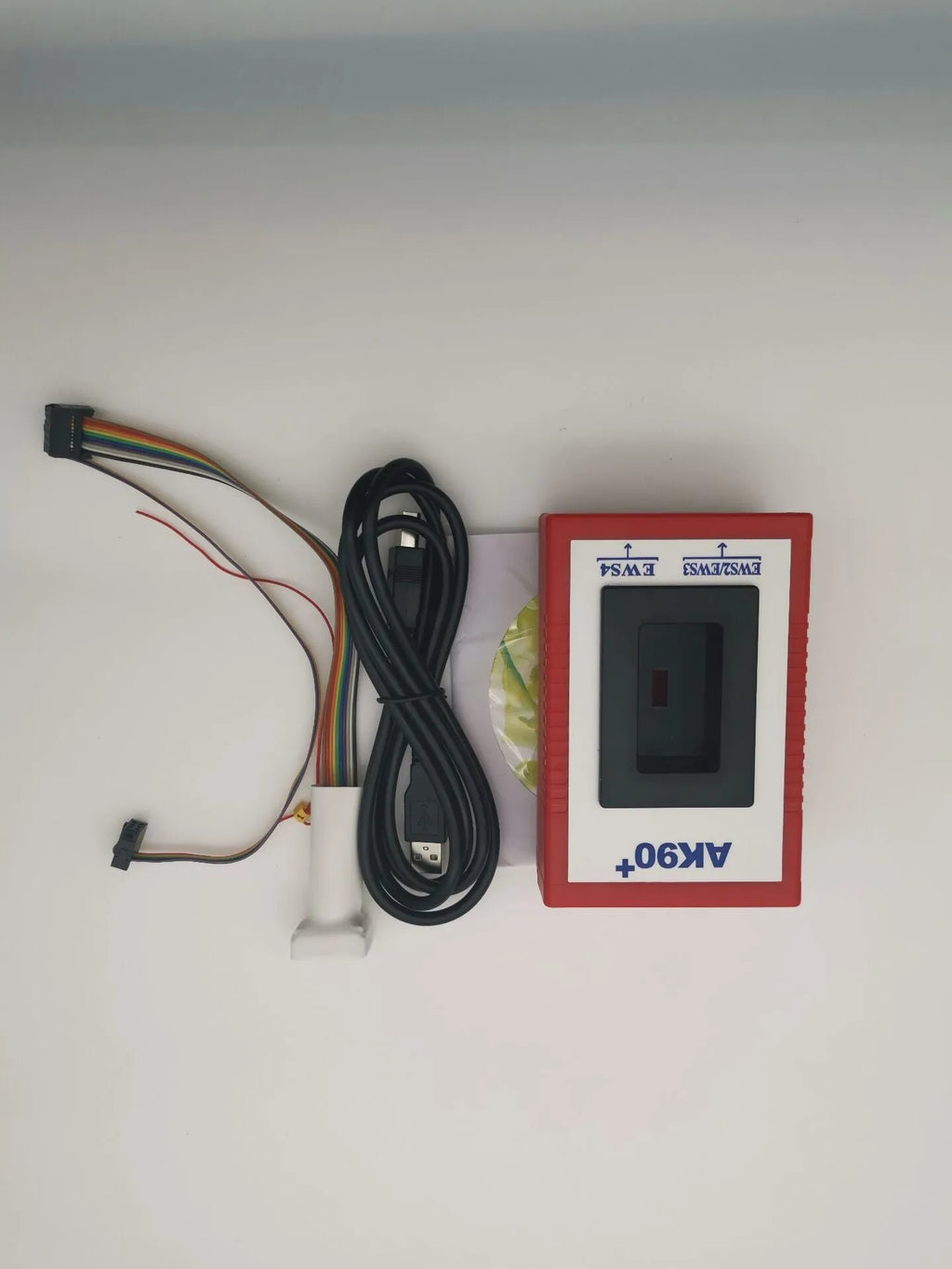 Red anti-theft key matching instrument car fault diagnosis tool on workshop bench