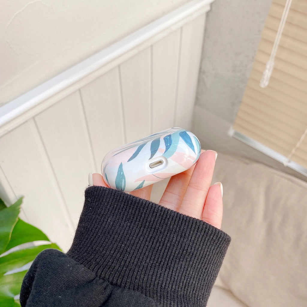 Green TPU protective case for AirPods with a painted banana leaves pattern design.