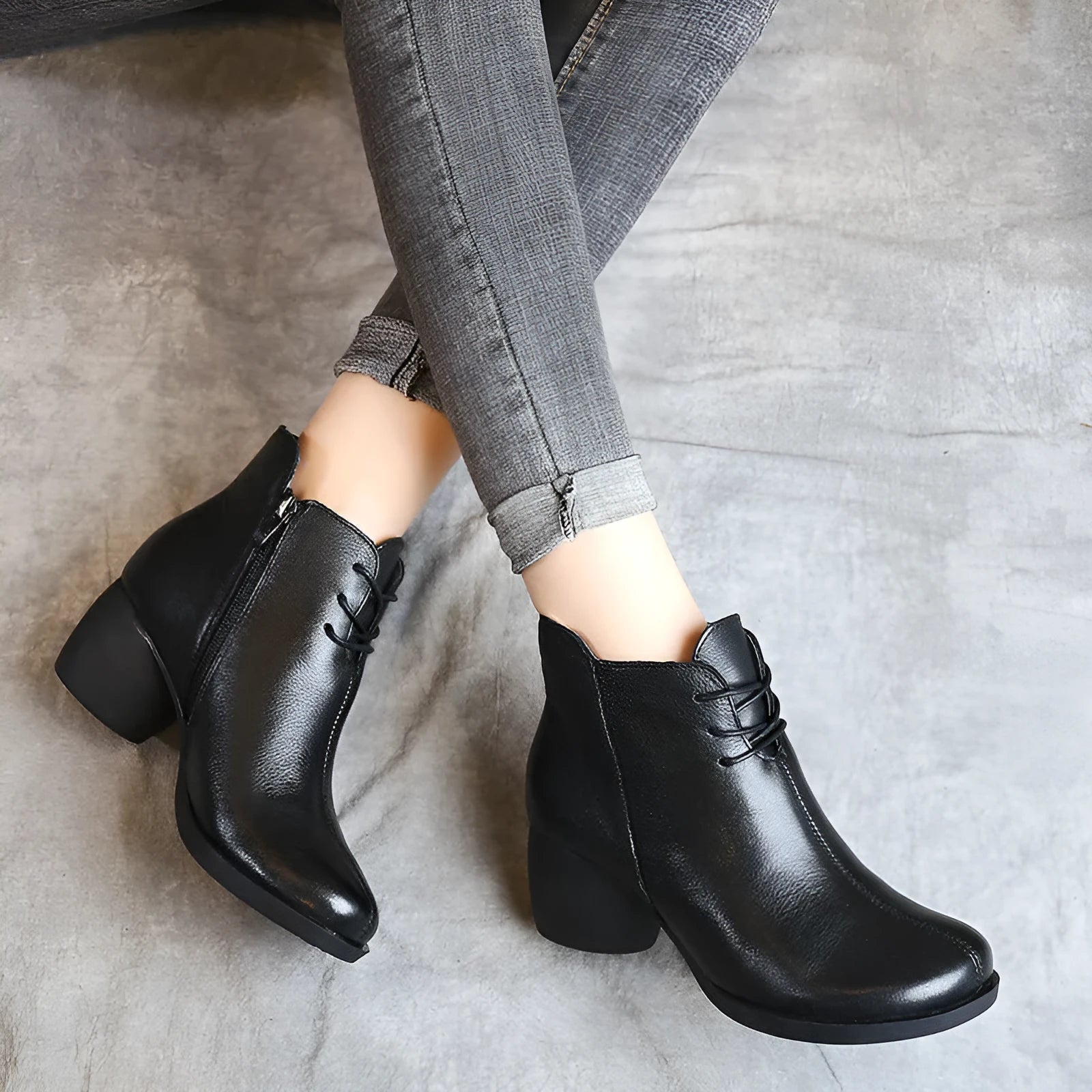 Women's brown leather Martin boots with a thick block heel and round toe on a wooden floor.