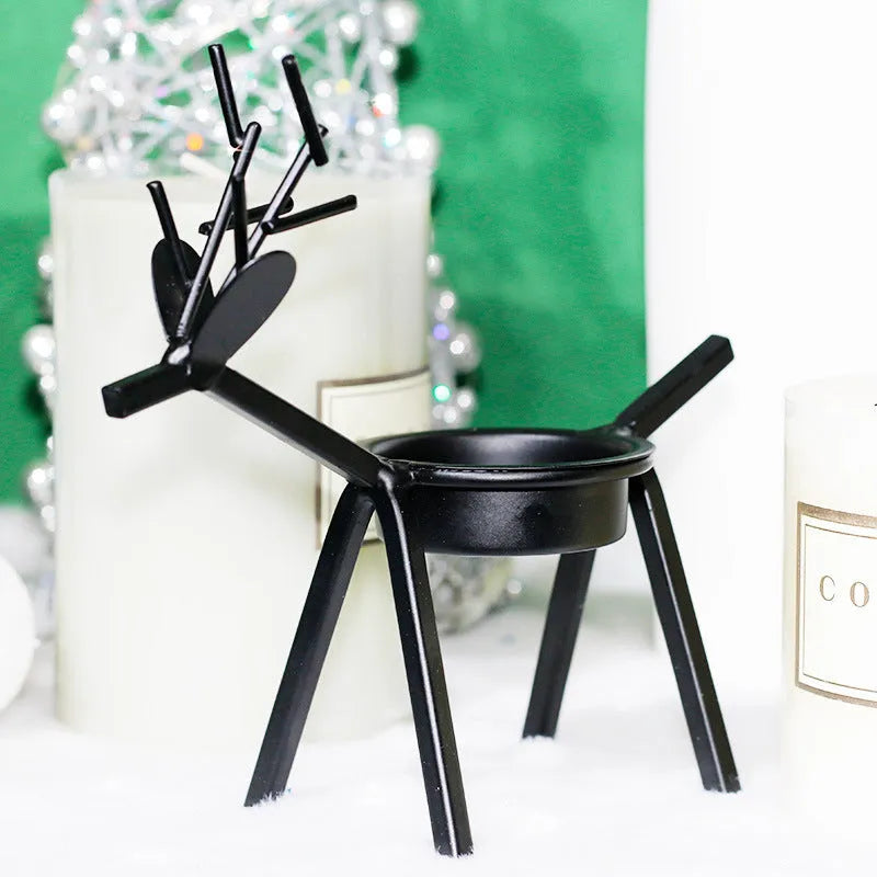 Black iron Christmas candlestick holder with detailed elk and deer design