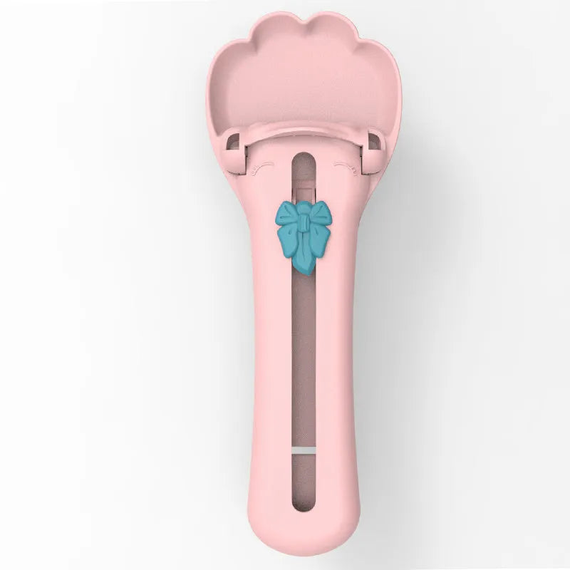 Green and pink pet feed spoon with silicone barrel for squeezing out sticky dog or cat food.