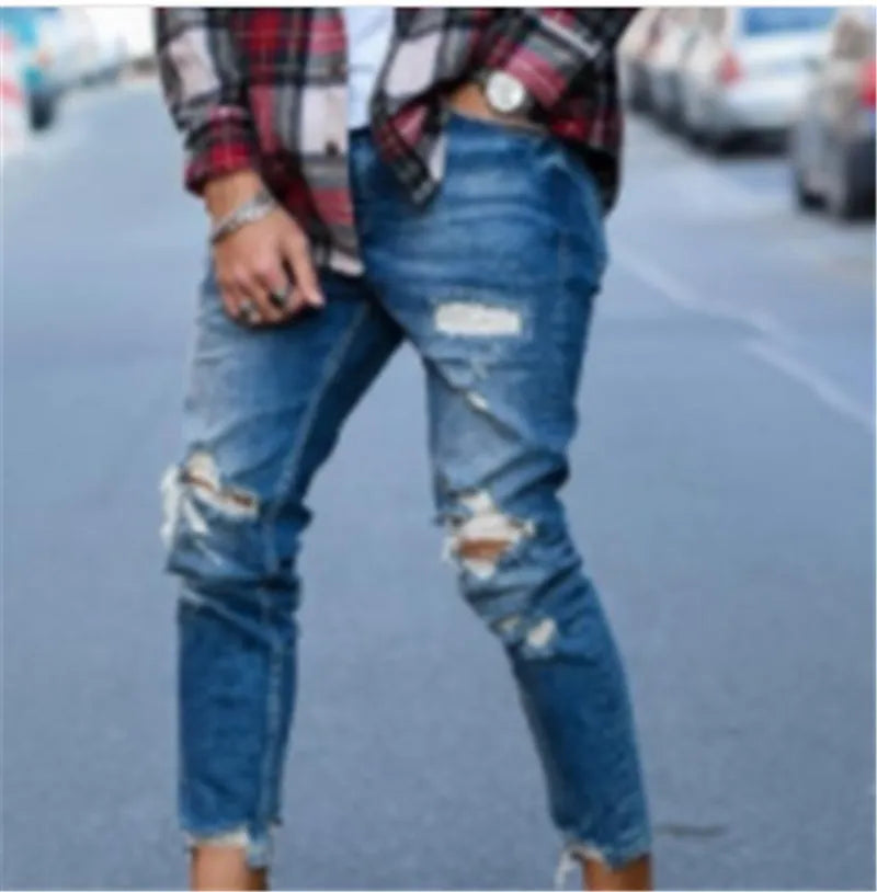 Men's deep blue cotton jeans featuring distressed hole details on the legs.