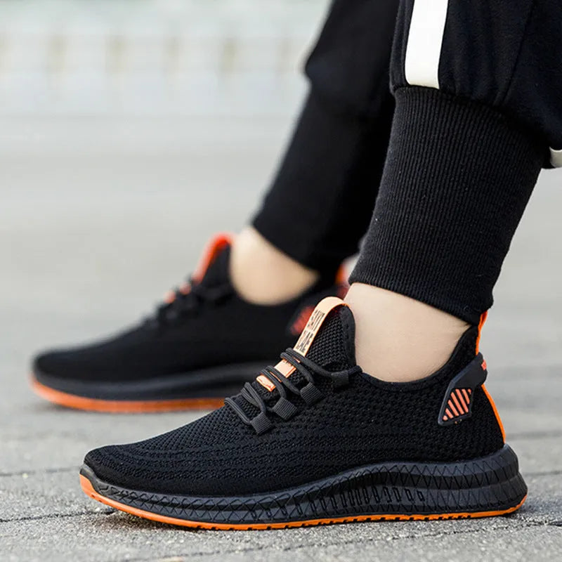 Men's fly woven casual sneakers in orange with flat heel and round toe design