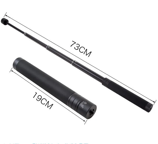 Black aluminium retractable selfie stick extended to full length with phone attached, showing included tripod stand and wireless remote.