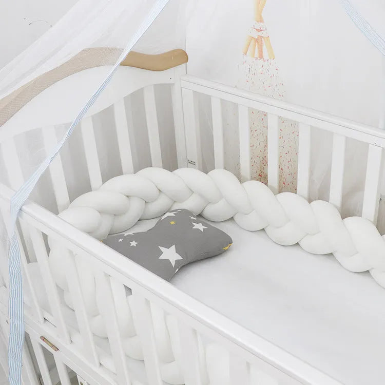 Soft spandex velvet baby crib bumper protector shown in a light grey colour, shaped around white crib bars.