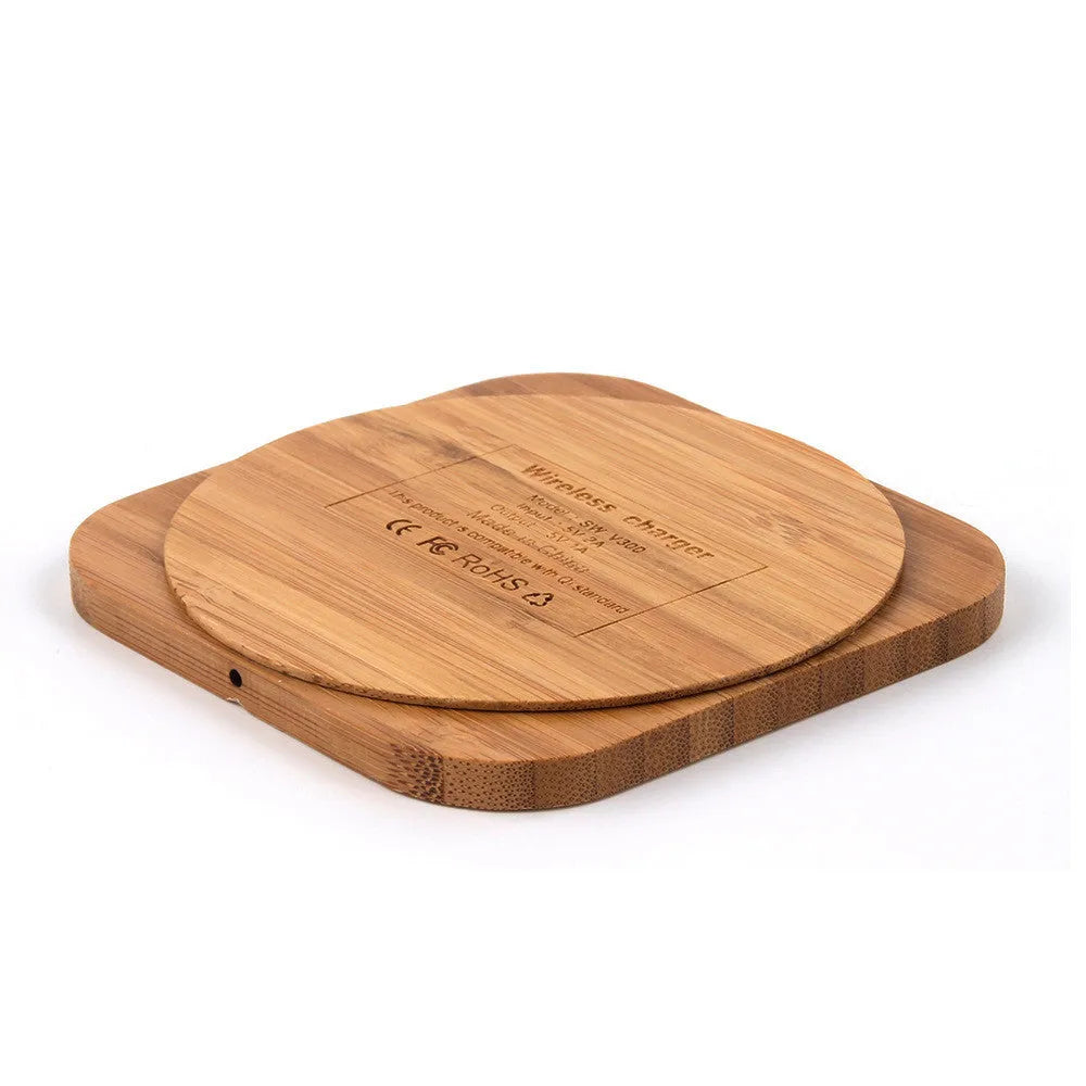 Square brown heart-shaped wooden bamboo 5W wireless charging pad on a table.