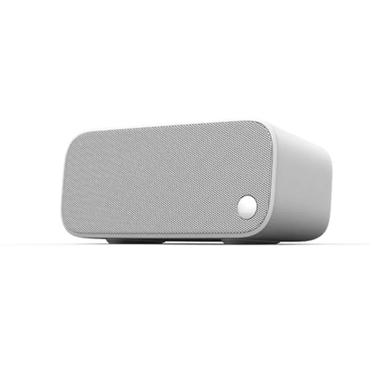 Compact Elf sugar cube AI smart WiFi speaker in blue colour on a wooden shelf